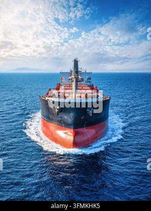 Close-up front view of a universal bulk carrier cargo ship traveling over blue ocean Stock Photo