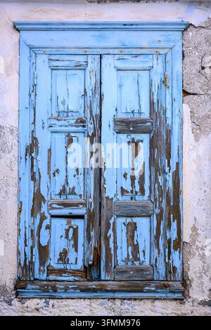 Old wooden door on a window in Greece Stock Photo