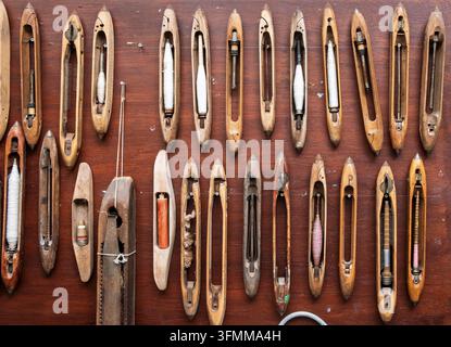 A shuttle  tool designed to neatly and compactly store a holder that carries the thread of the weft yarn while weaving with a loom. Stock Photo
