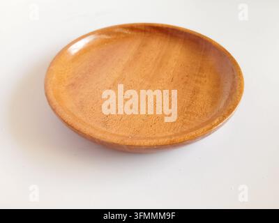 Empty round wooden plate or tray isolated on white background Stock Photo