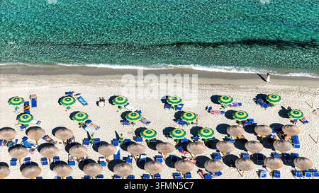 Umbrellas at Spiaggia di Cea beach, 28.09.2026. The Spiaggia di Cea beach, a sandy beach over a kilometer long and blue-green seawater, Tortoli, Italy Stock Photo