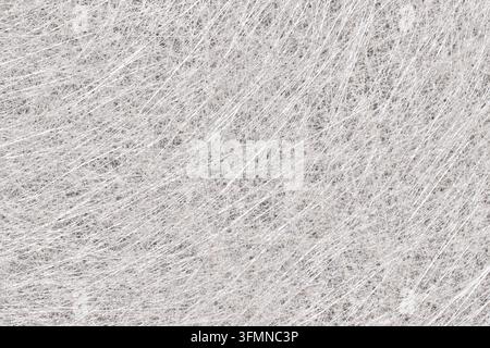 Macro close up of white fiberglass strand mat texture. Non woven glass fiber composite material background for industrial and construction design Stock Photo