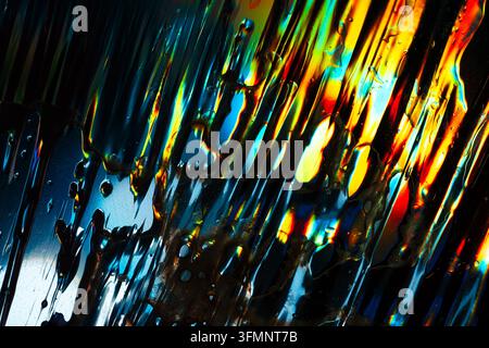 Iridescent fluid creating an abstract, vibrant background with striking colorful reflections and a dynamic liquid texture Stock Photo