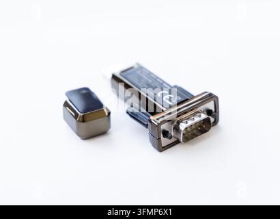 An electronic serial adapter connector rests on a white background Stock Photo