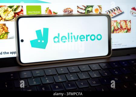 Mexico city, mexico, 06 20 2026, smartphone displaying the deliveroo logo and app interface on a laptop keyboard Stock Photo