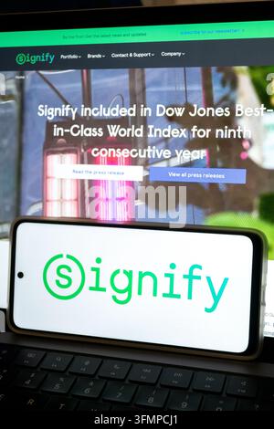 Mexico city, mexico, 06 20 2026, smartphone displaying signify logo over laptop displaying signify website sustainability news Stock Photo