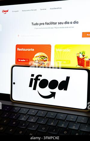 Mexico city, mexico, 06 20 2026, smartphone showing the ifood logo in front of a laptop displaying the ifood website Stock Photo