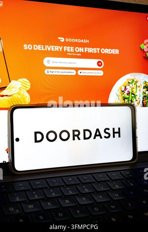 Mexico city, mexico, 06 20 2026, doordash logo on smartphone with application visible on laptop screen Stock Photo