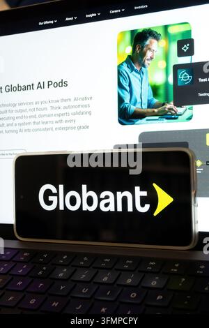 Mexico city, mexico, 06 20 2026, smartphone showing globant logo over a laptop displaying the company's ai services website Stock Photo