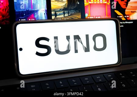 Mexico city, mexico, 06 24 2026, smartphone showing the suno ai logo resting on a keyboard, with blurred background moving images Stock Photo