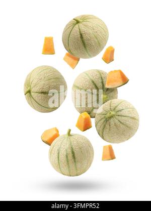 Fresh cantaloupe melons falling on white background. Whole and sliced Stock Photo