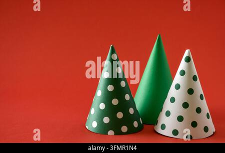 Three Christmas cone are arranged on a red background. Stock Photo