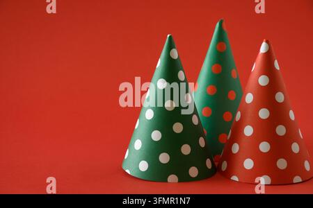 Three Christmas cone are arranged on a red background. Stock Photo