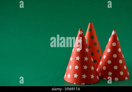 Three Christmas cone are arranged on a green background. Stock Photo