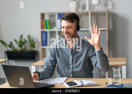 Smiling Caucasian Man Working From Home, Engaging In Online Meeting, Business Concept Stock Photo