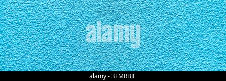 Macro panoramic photograph of a bright cyan suede leather surface displaying a soft velvety texture under diffuse lighting. Stock Photo