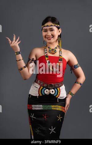 Three quarter portrait of a smiling young woman wearing traditional Simba dress of Murut Tahol tribe from Sabah Malaysia. Stock Photo