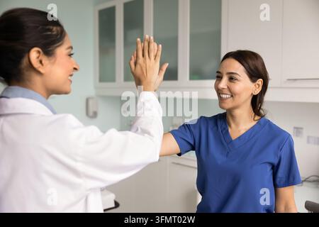 Doctor and nurse giving high five in hospital Stock Photo