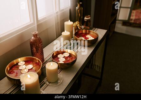 Burning Candles with Floating Tea Lights Arranged for Celebration Stock Photo