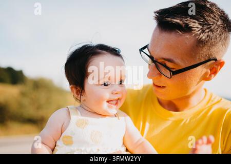 Father Holding Smiling Baby Daughter Outdoors On Sunny Summer Day — Family Bonding Portrait Stock Photo