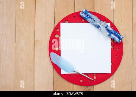 Blank Christmas Letter Paper with Feather Pen and Ribbon Tied Scrolls Stock Photo
