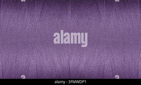 A detailed macro image of tightly wound sewing threads in a rich Purple color. The distinct cross-weave creates a rhythmic geometric pattern, ideal fo Stock Photo