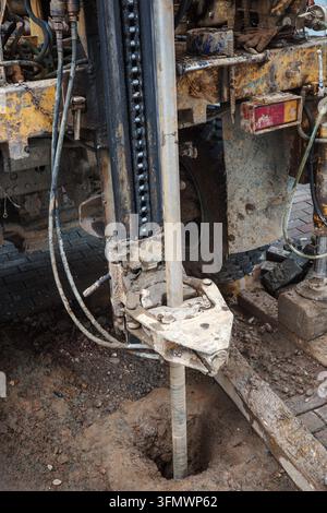 Geotechnical drilling rig with borehole rod, hydraulic mast and soil machinery working at construction site during subsurface engineering investigation. Stock Photo