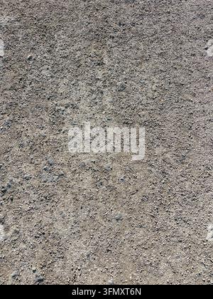 Rough gray asphalt surface texture with small pebbles and weathered detail Stock Photo