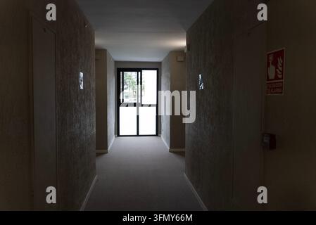 Dark Residential Building Corridor With Fire Alarm And Exit Door Stock Photo
