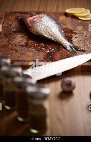 Fresh dorado fish preparing on wooden cutting board Stock Photo