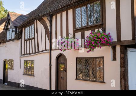An old timber-framed building with hanging baskets on Castle Street in Warwick, UK. Stock Photo