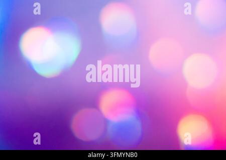 Soft abstract bokeh background featuring blurred circles of pink, purple, blue, cyan, and warm yellow light, creating a dreamy luminous atmosphere wit Stock Photo