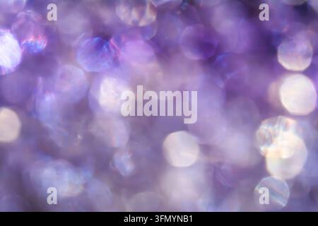 Dreamy abstract background featuring soft purple, violet and lavender bokeh circles with glowing highlights, creating an ethereal, blurred texture for Stock Photo