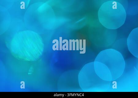 Abstract blue and turquoise bokeh background featuring soft luminous circular light spots, blurred gradients, and a dreamy atmospheric texture for mod Stock Photo