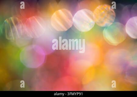 Vibrant abstract background with multicolored bokeh circles, soft glowing light, and blurred rainbow hues. Ideal for festive design, celebration, drea Stock Photo