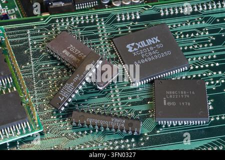 Florence, Italy - 23th december 2025: Vintage green computer motherboard with retro semiconductor components, microprocessors and microchips Stock Photo