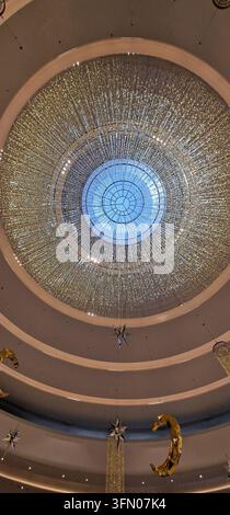 A stunning overhead shot captures the intricate details of a grand dome ceiling adorned with thousands of shimmering lights. The circular design and c Stock Photo