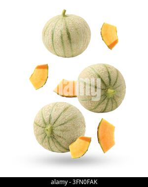 Fresh cantaloupe melons falling on white background. Whole and sliced Stock Photo