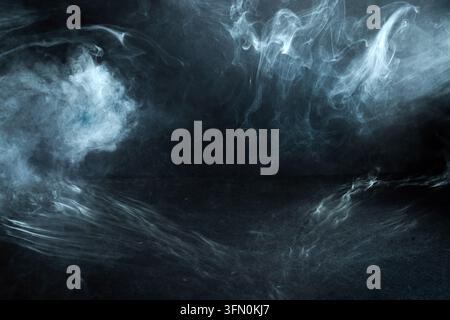 White smoke flowing on dark abstract background Stock Photo