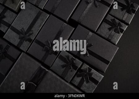 Black gift boxes with ribbon bows for luxury celebration Stock Photo