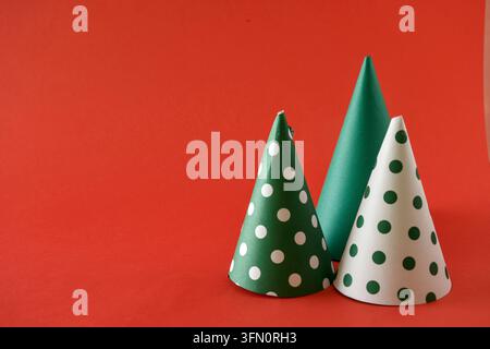 Three Christmas cone are arranged on a red background. Stock Photo