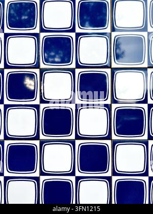 Blue and white azulejo ceramic tiles with a retro geometric square pattern on a wall in Portugal Stock Photo