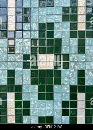 Wall of green, turquoise and cream square glazed ceramic azulejo mosaic tiles in Portugal, full frame Stock Photo