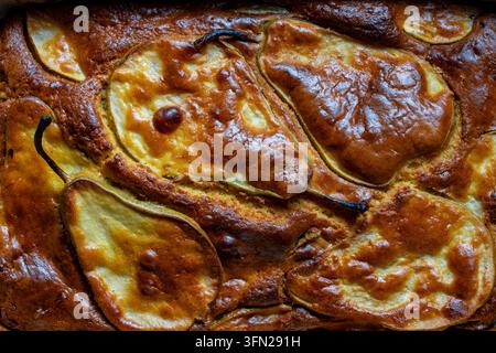Close up texture of homemade pear pie. Top down view of delicious freshly baked pear cake texture with caramelized golden brown crust and whole sliced Stock Photo