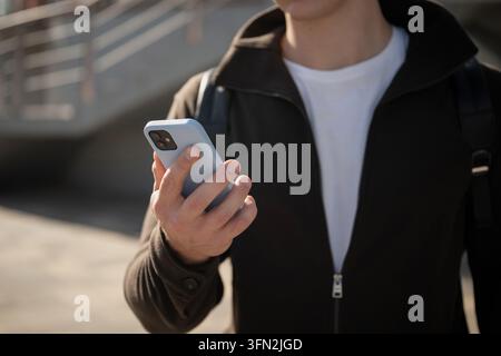 Man using smartphone outdoors in modern city Stock Photo