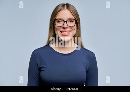 Smiling young woman wearing eyeglasses looking at camera portrait Stock Photo