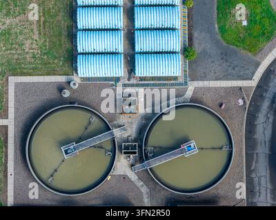Aerial view of the wastewater treatment plant with circular sedimentation tanks and blue storage structures in Woodburn, Oregon, United States. Stock Photo