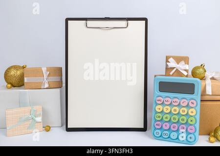 Christmas Budget Planning with Calculator Clipboard and Gift Boxes  Stock Photo