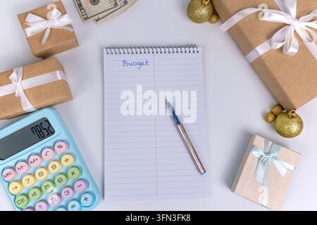 Christmas Budget Planning with Calculator Money Notebook and Gift Boxes  Stock Photo
