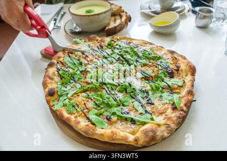 Halifax Nova Scotia Canada,Downtown South Park Street,Public Cafe & Bar restaurant,pizza,arugula topping,balsamic glaze,cheese,caramelized onions,thin Stock Photo